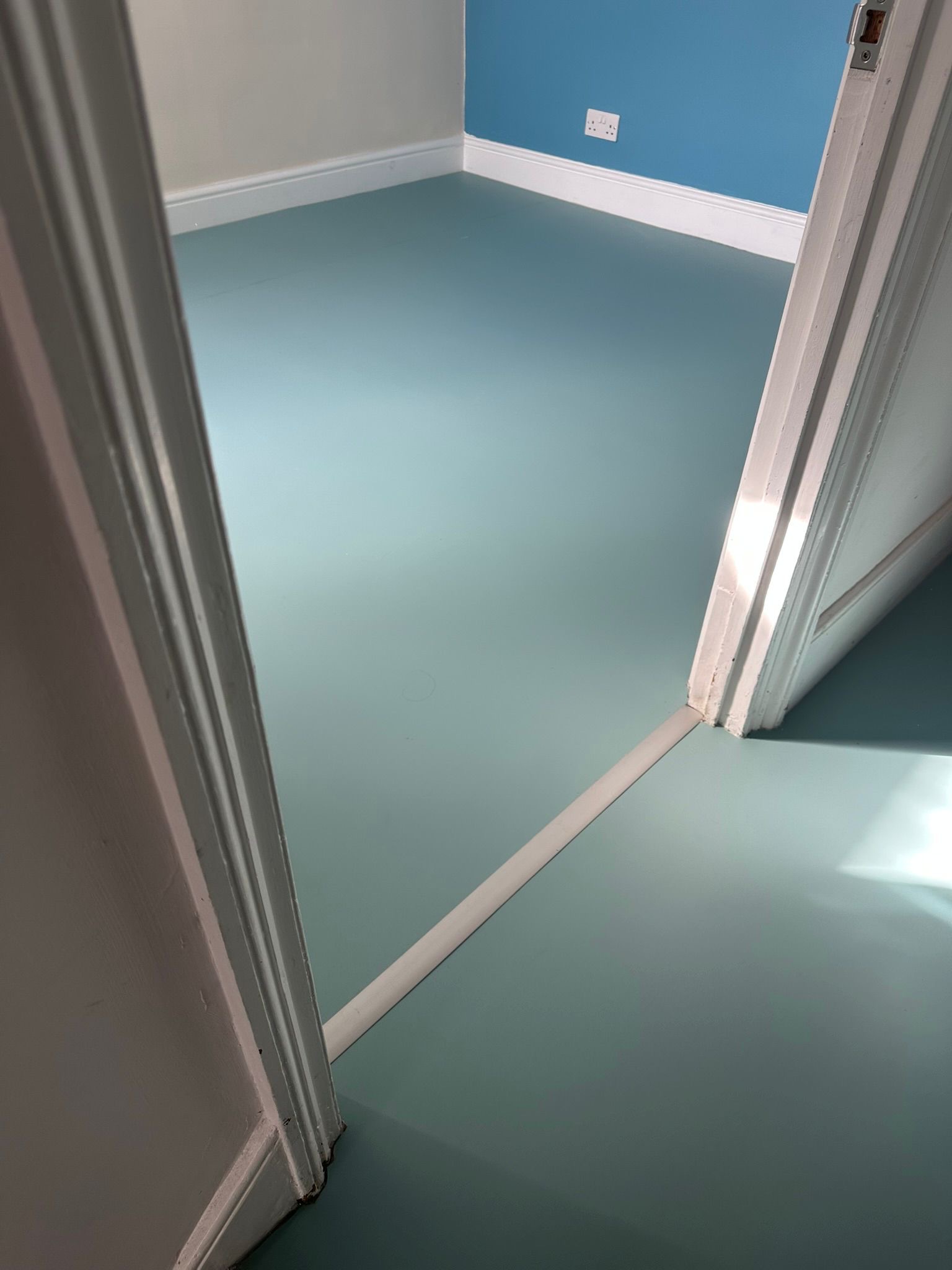 Soft blue Colour Flooring installed in a bedroom