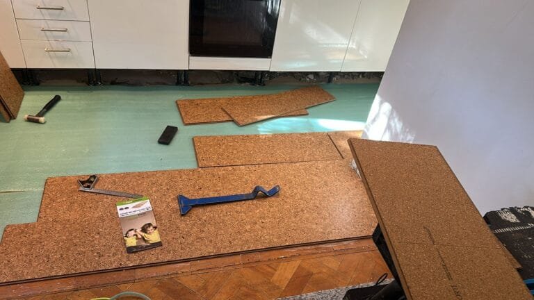 Cork tiles being laid across a London kitchen floor