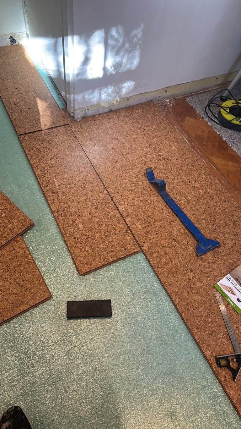 Cork tiles being fitted over the prepared subfloor